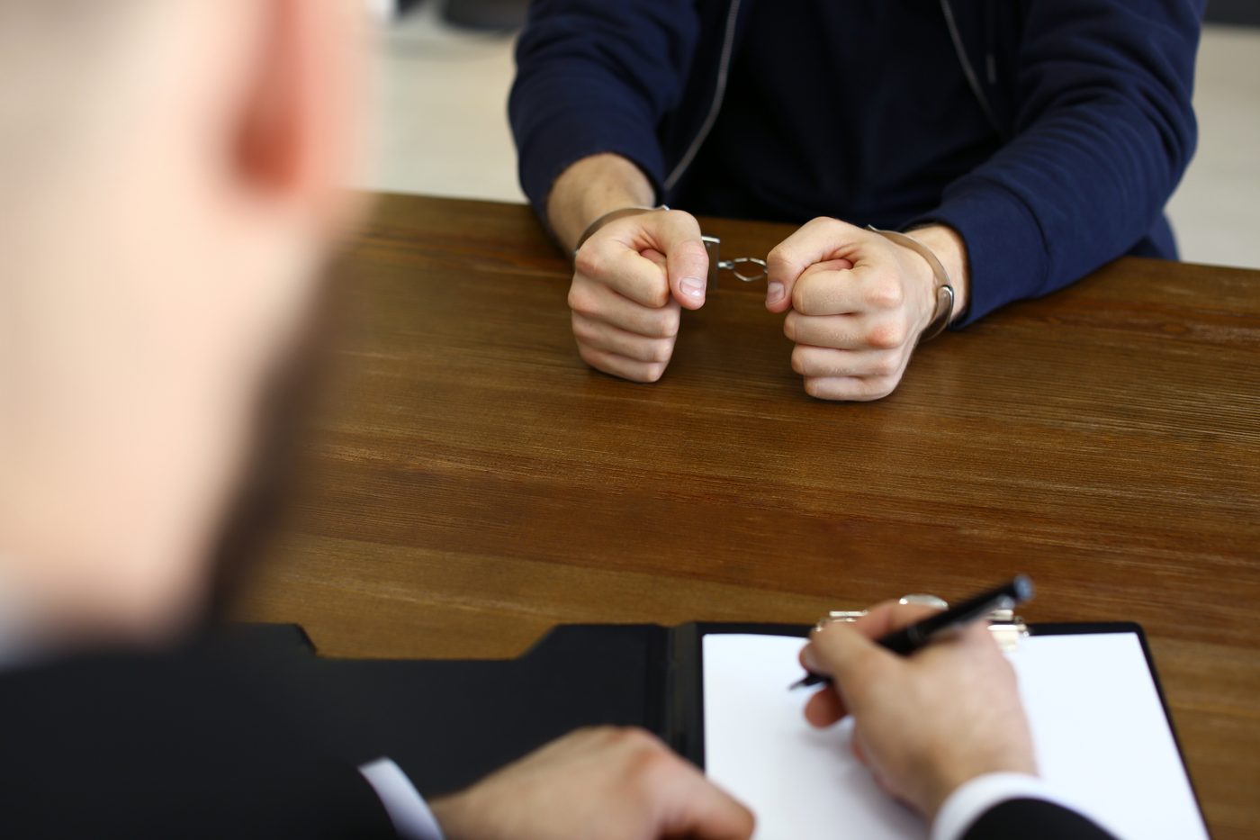 A confidential consultation across a desk in a law office