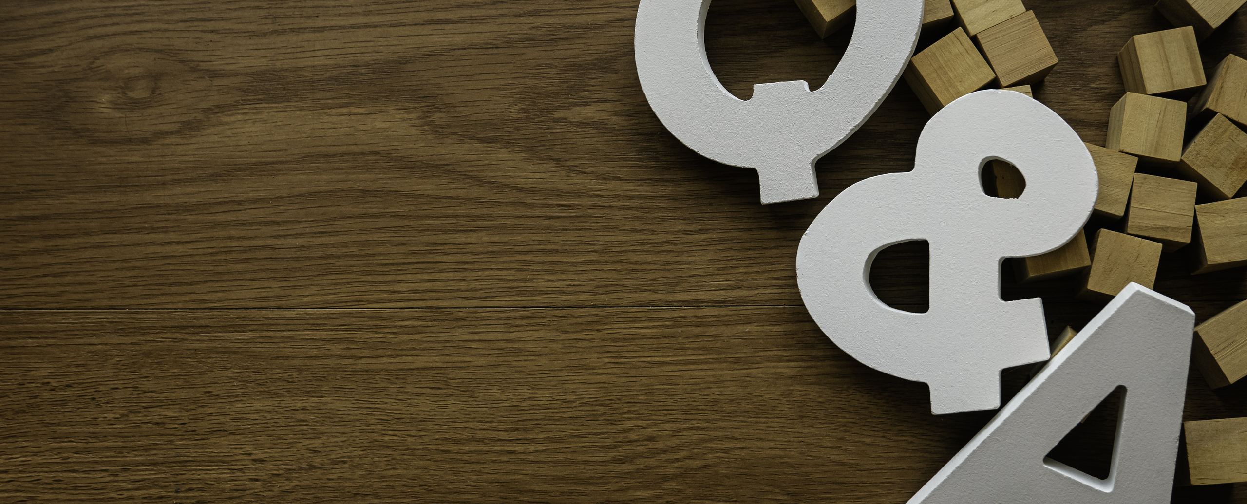 White letters spelling Q and A on a dark wooden surface