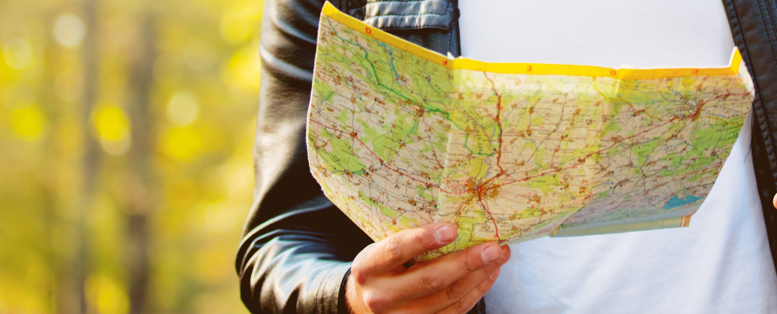 A road map held open, its road network and towns in close detail