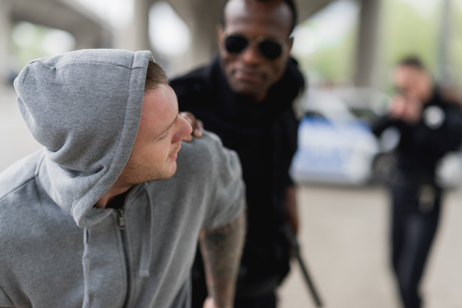 A police officer detaining a young man on the street — why a criminal defense lawyer matters