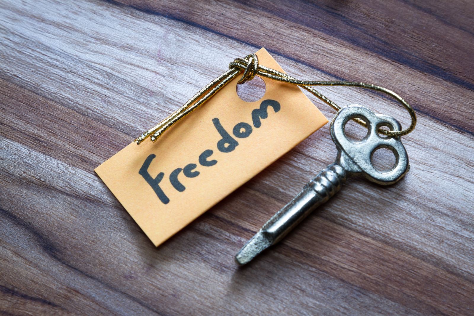 A key with a paper tag reading &ldquo;Freedom&rdquo;