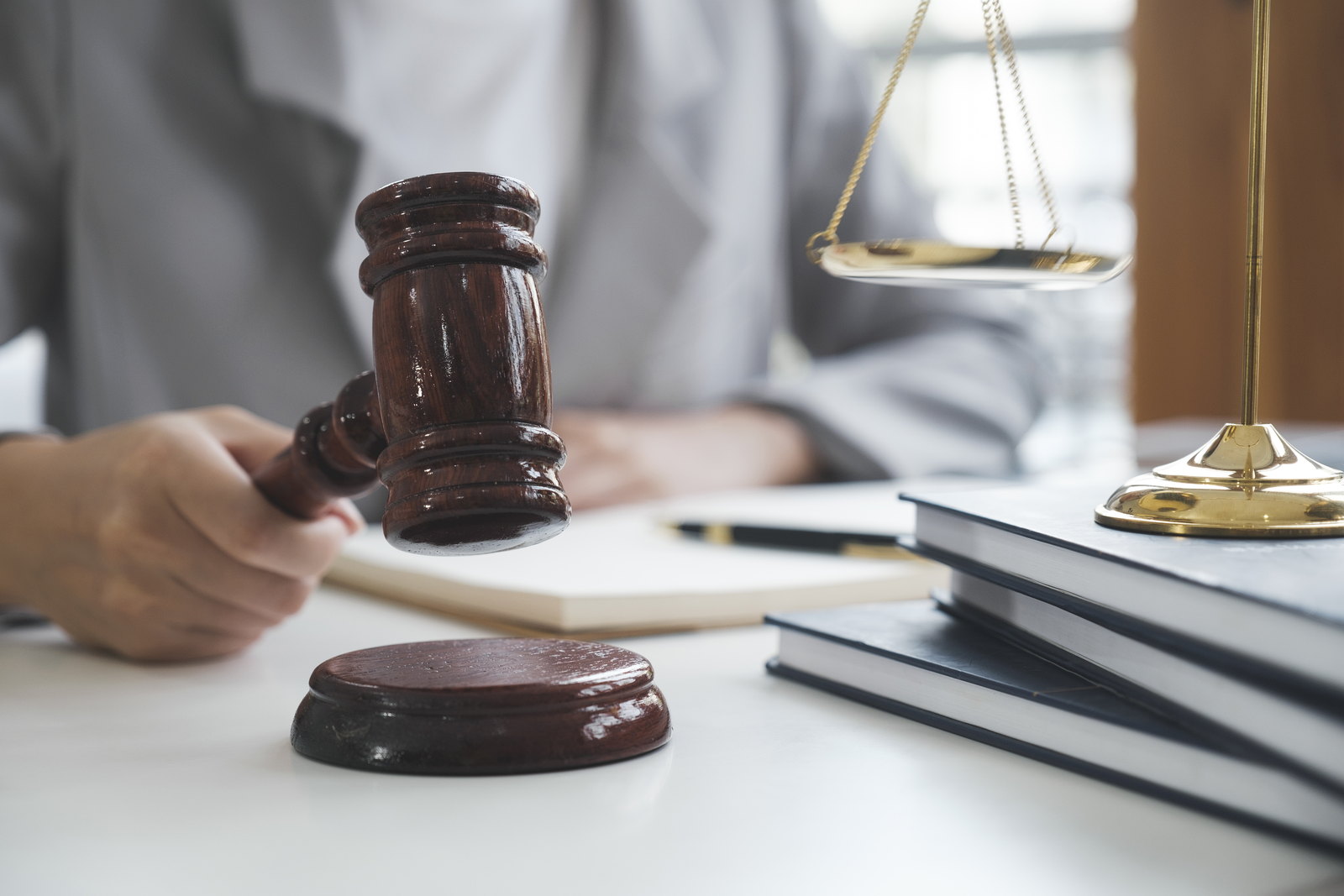 Scales of justice and a gavel on a law office desk
