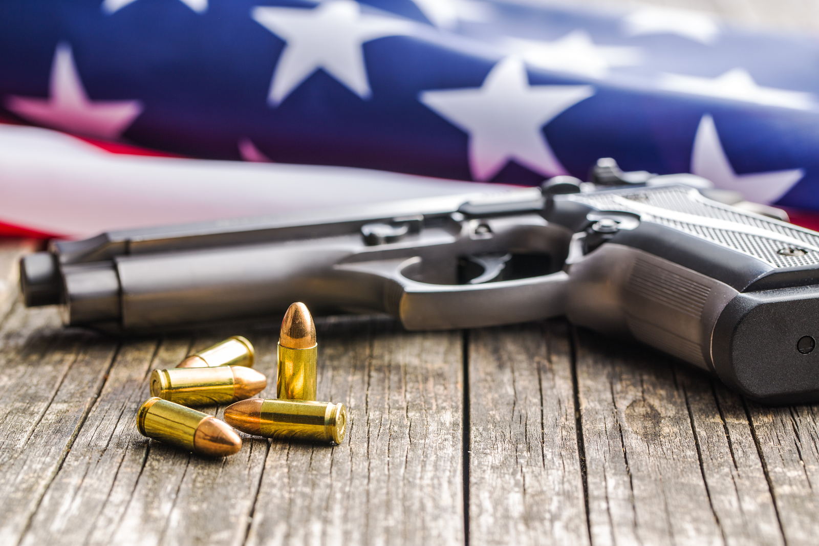 Handgun and ammunition against a United States flag