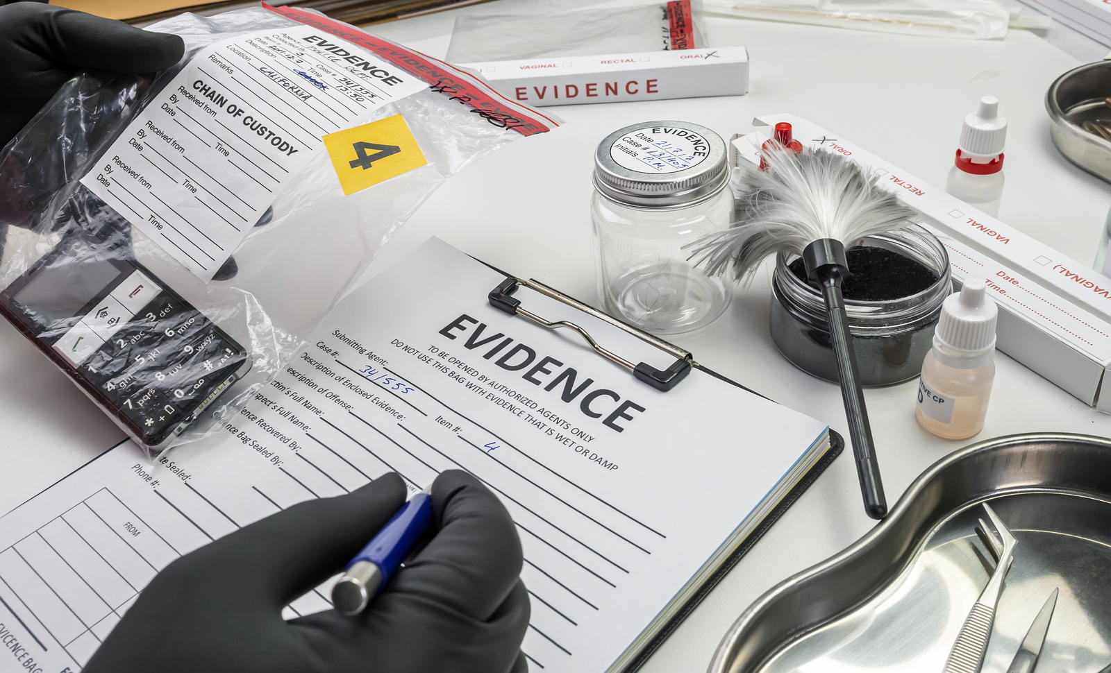 An investigator cataloguing evidence and chain-of-custody forms