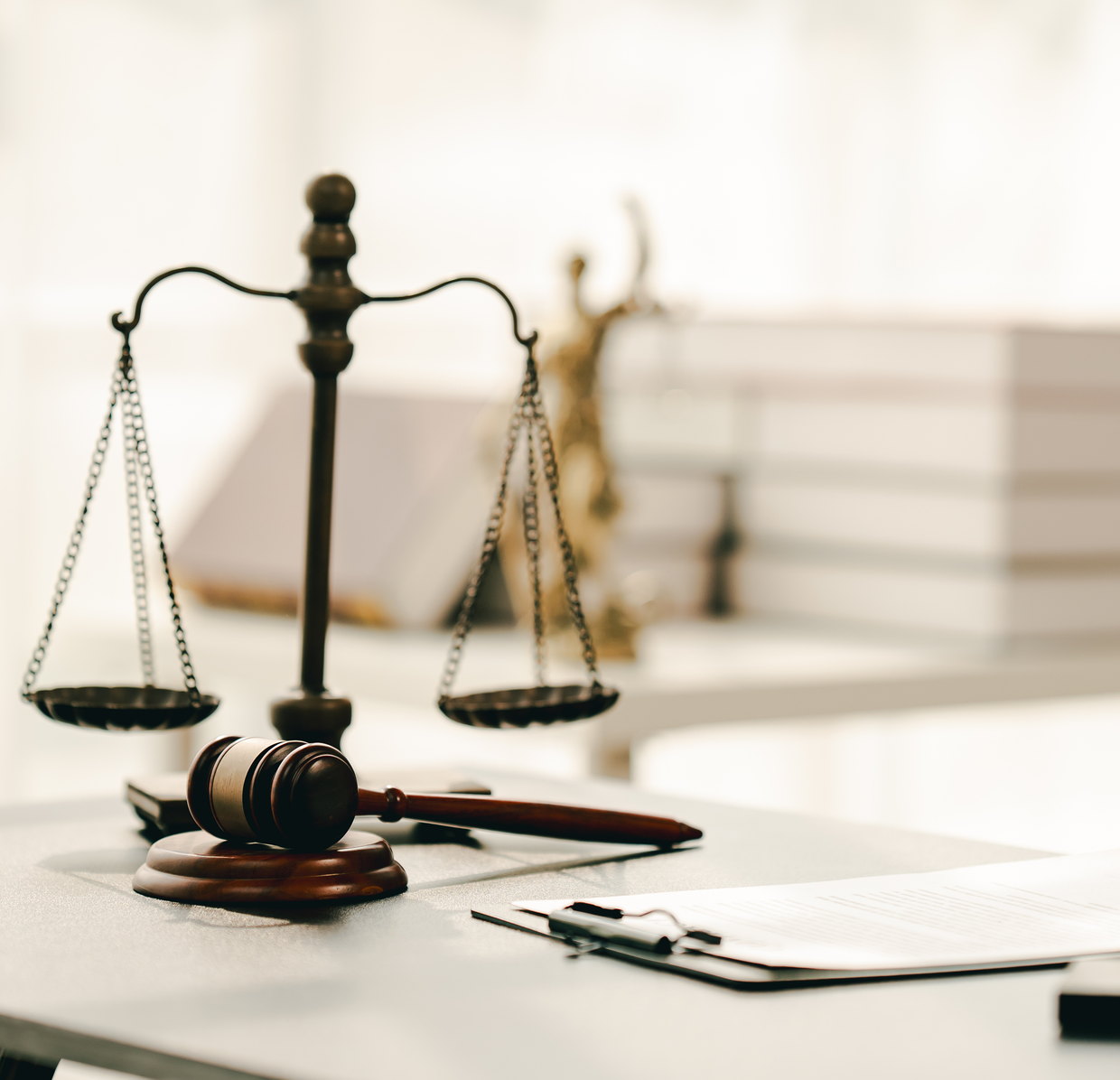 Scales of justice and a gavel on a courtroom desk